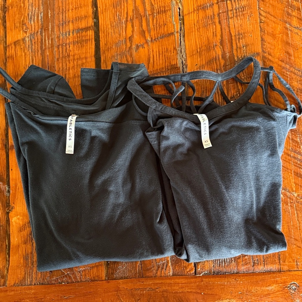 Two Fabletics long sleeve tees size XS black “Storm and Sunburst”